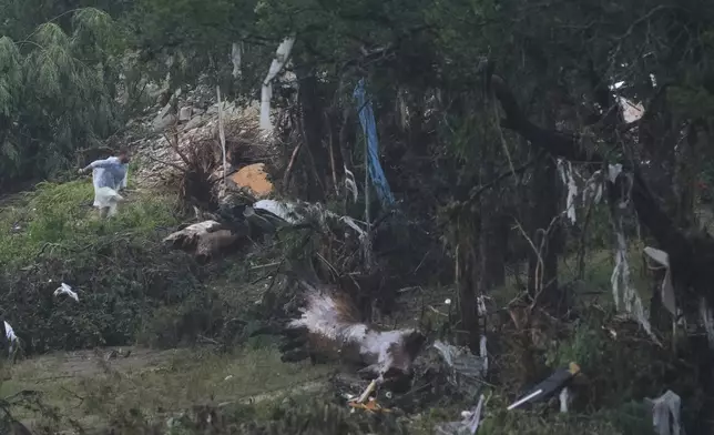 A man surveys damage left by a raging Guadalupe River, Friday, July 4, 2025, in Kerrville, Texas. (AP Photo/Eric Gay)