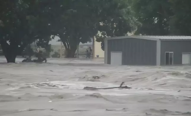 Water rises from severe flooding along the Guadalupe River.in Kerr County, Texas on Friday, July 4, 2025. (KSAT via AP)