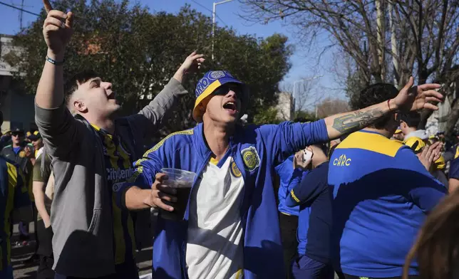 Rosario Central soccer fans get revved up as they arrive for a soccer match in Buenos Aires, Saturday, July 19, 2025, after the soccer federation lifted a 12-year ban as a test run on away fans in Argentina’s local leagues. (AP Photo/Gustavo Garello)