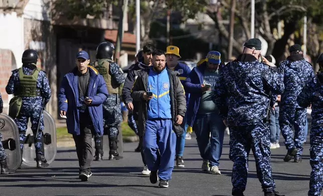 Police patrol as Rosario Central soccer fans arrive for a soccer match in Buenos Aires, Saturday, July 19, 2025, after the soccer federation lifted a 12-year ban as a test run on away fans in Argentina’s local leagues. (AP Photo/Gustavo Garello)