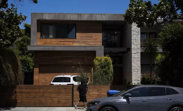 A person records the residency of Mexican boxer Julio César Chávez Jr., Thursday, July 3, 2025, in Los Angeles. (AP Photo/Jae C. Hong)