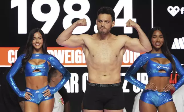 Julio Cesar Chavez Jr., center, poses during a weigh-in ahead of his cruiserweight boxing match against Jake Paul, Friday, June 27, 2025, in Anaheim, Calif. (AP Photo/Chris Pizzello)