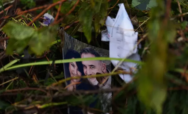 A family portrait is caught in debris along the Guadalupe River after a flash flood struck the area, Friday, July 4, 2025, in Kerrville, Texas. (AP Photo/Eric Gay)