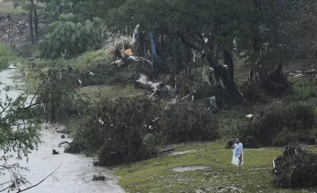 A man surveys damage left by a raging Guadalupe River, Friday, July 4, 2025, in Kerrville, Texas. (AP Photo/Eric Gay)
