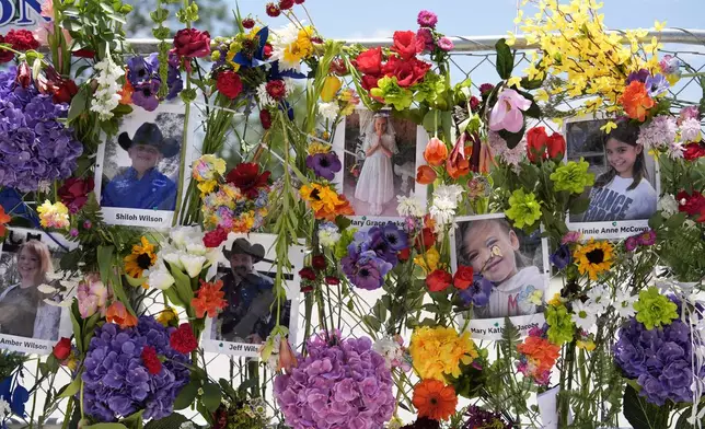 Photographs of flood victims are displayed on a memorial wall in Kerrville, Texas, Thursday, July 10, 2025. (AP Photo/Ashley Landis)