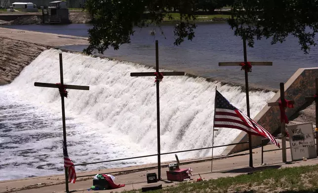 Crosses were erected as a memorial for victims of the flash flood along the Guadalupe River in Kerrville, Texas, Thursday, July 10, 2025. (AP Photo/Gerald Herbert)