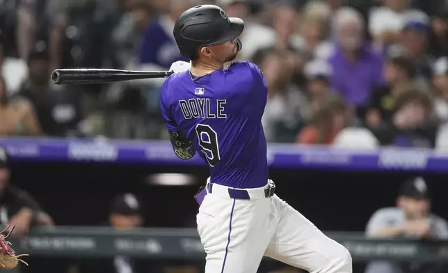 Colorado Rockies pinch hitter Brenton Doyle follows the flight of his solo home run off Chicago White Sox relief pitcher Brandon Eisert in the eighth inning of a baseball game Saturday, July 5, 2025, in Denver. (AP Photo/David Zalubowski)