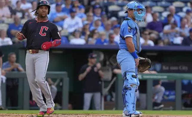 Cleveland Guardians' Jose Ramirez runs home to score past Kansas City Royals catcher Freddy Fermin on a two-run double hit by Johnathan Rodriguez during the first inning in the second baseball game of a doubleheader against the Kansas City Royals, Saturday, July 26, 2025, in Kansas City, Mo. (AP Photo/Charlie Riedel)