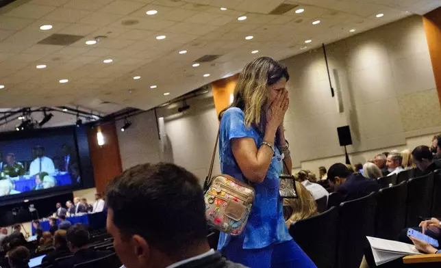 Christina Stovall, whose son, Mikey Stovall, died on American Airlines flight 5342 in a collision with a U.S. military helicopter, weeps as she leaves the room during the NTSB fact-finding hearing on the DCA midair collision accident, at the National Transportation and Safety Board boardroom, Wednesday, July 30, 2025, in Washington. (AP Photo/Rod Lamkey, Jr.)