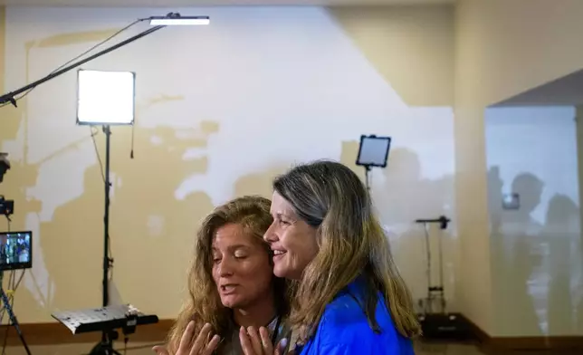 Ashleigh Stovall, left, is joined by her mother in-law Christina Stovall, right, as she talks about her husband, Mikey Stovall, who perished on American Airlines flight 5342 in a collision with a U.S. military helicopter, during the NTSB fact-finding hearing on the DCA midair collision accident, at the National Transportation and Safety Board boardroom, Wednesday, July 30, 2025, in Washington. (AP Photo/Rod Lamkey, Jr.)