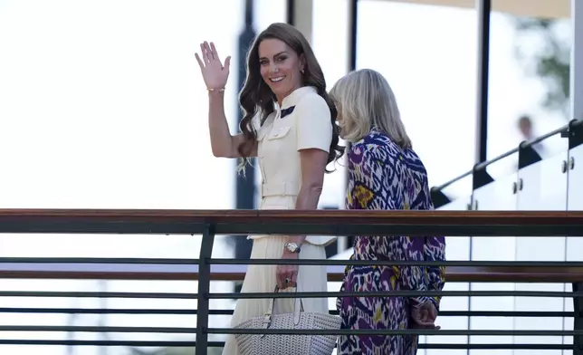 Britain's Kate, Princess of Wales waves as she arrives with Deborah Jevans of the All England Club to attend the women's singles final between Poland's Iga Swiatek and Amanda Anisimova of the US at the Wimbledon Tennis Championships in London, Saturday, July 12, 2025. (Andrew Matthews/PA via AP)