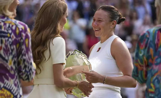 Amanda Anisimova of the U.S. receives her runners-up trophy from Kate, Princess of Wales, after losing to Poland's Iga Swiatek during the women's single final at the Wimbledon Tennis Championships in London, Saturday, July 12, 2025. (AP Photo/Kin Cheung)