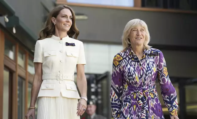 Britain's Kate, Princess of Wales, with AELTC chair Debbie Jevans, right, arrives to attend the women's singles final between Poland's Iga Swiątek and Amanda Anisimova of the US at the Wimbledon Tennis Championships in London, Saturday, July 12, 2025. (Jordan Pettitt/Pool via AP)