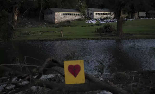A broken heart sign is displayed near Camp Mystic on Tuesday, July 8, 2025, after a flash flood swept through the area in Hunt, Texas. (AP Photo/Eli Hartman)