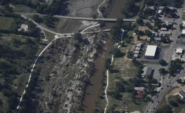 Water flows through the Guadalupe River on Tuesday, July 8, 2025, after a flash flood swept through the area in Kerrville, Texas. (AP Photo/Ashley Landis)