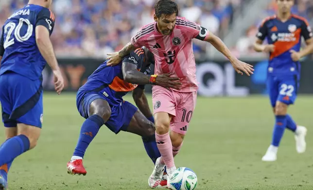 Inter Miami's Lionel Messi, right, keeps the ball away from FC Cincinnati's Tah Brian Anunga during the first half of an MLS soccer match, Wednesday, July 16, 2025, in Cincinnati. (AP Photo/Jay LaPrete)