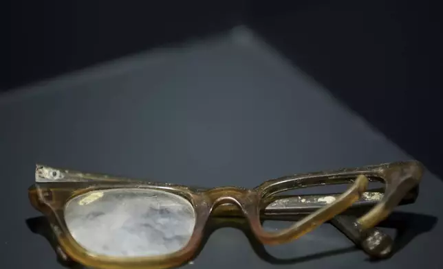 Eyeglasses found in a mass grave are shown as a part of the exhibition "Lives Beyond the Fields of Death" opened at the Srebrenica Memorial Center in Potocari, Bosnia, Thursday, July 10, 2025. (AP Photo/Armin Durgut)