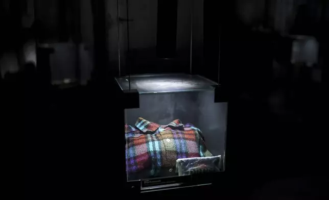 A shirt found in a mass grave is shown as a part of the exhibition "Lives Beyond the Fields of Death" opened at the Srebrenica Memorial Center in Potocari, Bosnia, Thursday, July 10, 2025. (AP Photo/Armin Durgut)