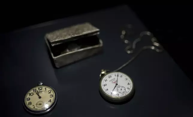 Pocket watches found in a mass grave are shown as a part of the exhibition "Lives Beyond the Fields of Death" opened at the Srebrenica Memorial Center in Potocari, Bosnia, Thursday, July 10, 2025. (AP Photo/Armin Durgut)