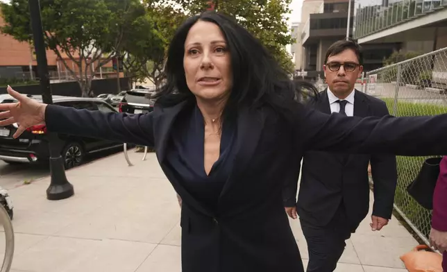 Dr. Salvador Plasencia, right, walks behind his Attorney Debra S. White as he leaves federal court on Wednesday, July 23, 2025 in Los Angeles, after pleading guilty to giving ketamine to Matthew Perry, leading up to the actor's 2023 overdose death. (AP Photo/Damian Dovarganes)