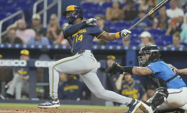 Milwaukee Brewers' Andruw Monasterio (14) hits a single to center field during the second inning of a baseball game against the Miami Marlins, Sunday, July 6, 2025, in Miami. (AP Photo/Marta Lavandier)