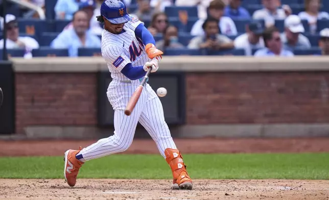New York Mets' Francisco Lindor hits an RBI single during the fourth inning of a baseball game against the Los Angeles Angels Wednesday, July 23, 2025, in New York. (AP Photo/Frank Franklin II)