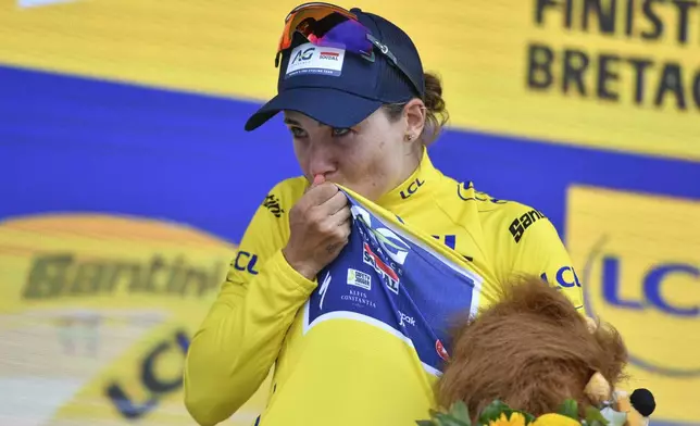 Mauritius' Kim Le Court Pienaar kisses the overall leader's yellow jersey after the second stage of the Women' s Tour de France cycling race that starts in Brest to finish in Quimper, Sunday, July 27, 2025 in Quimper, Brittany, western France. (AP Photo/Mathieu Pattier)