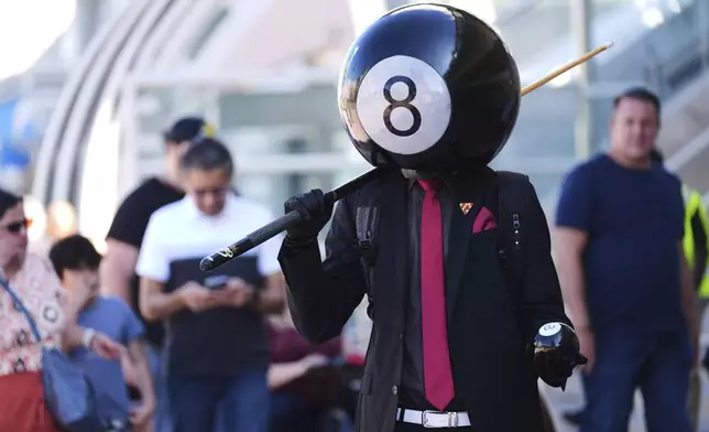 Andrew Ghannadian, of San Diego, dressed in his own costume as "Eight-ball," walks through the crowd before the 2025 Comic-Con International Preview Night on Wednesday, July 23, 2025, in San Diego. (AP Photo/Chris Pizzello)