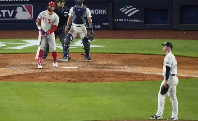 New York Yankees pitcher Ian Hamilton and catcher Austin Wells watch a ball hit by Philadelphia Phillies' Kyle Schwarber for a two-run home run during the eighth inning of a baseball game Friday, July 25, 2025, in New York. (AP Photo/Frank Franklin II)