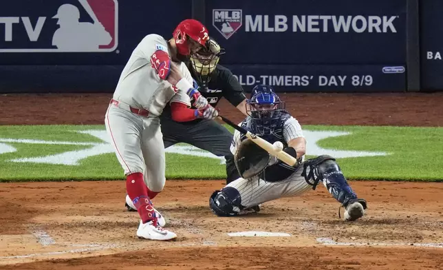 Philadelphia Phillies' Kyle Schwarber hits a two-run home run during the fifth inning of a baseball game against the New York Yankees Friday, July 25, 2025, in New York. (AP Photo/Frank Franklin II)