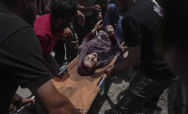 A woman is evacuated after an Israeli strike on tents sheltering displaced Palestinians in Gaza City on Tuesday, July 8, 2025. (AP Photo/Jehad Alshrafi)