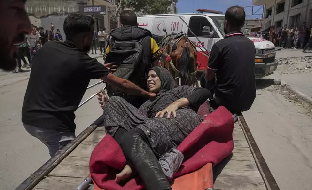 A woman is evacuated after an Israeli strike on tents sheltering displaced Palestinians in Gaza City on Tuesday, July 8, 2025. (AP Photo/Jehad Alshrafi)
