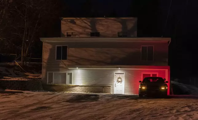FILE - A private security officer sits in a vehicle on Jan. 3, 2023, in front of the house in Moscow, Idaho, where four University of Idaho students were killed in November 2022. (AP Photo/Ted S. Warren, File)
