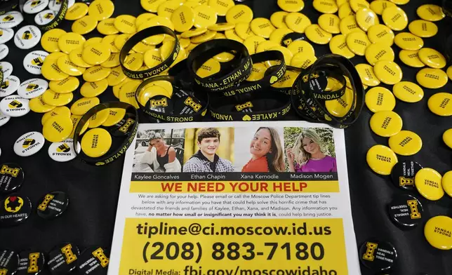 FILE - A flyer seeking information about the killings of four University of Idaho students who were found dead is displayed on a table along with buttons and bracelets on Nov. 30, 2022, during a vigil in memory of the victims in Moscow, Idaho. (AP Photo/Ted S. Warren, File)