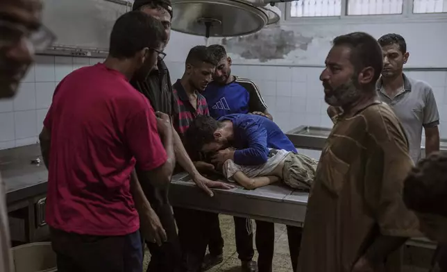 Palestinians mourn a child killed in an Israeli military airstrike on Gaza, at the morgue of Shifa Hospital in Gaza City, Saturday, July 12, 2025. (AP Photo/Jehad Alshrafi)