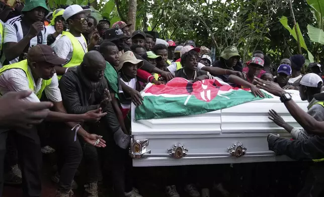 Boniface Kariuki, a vendor who was shot at close range by a police officer during last month's protests, is laid to rest at his parents' farm in Kangema, Muranga County, Kenya, Friday, July 11, 2025. (AP Photo/Brian Inganga)