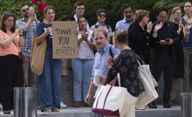 State Department employees applaud as their colleagues walk outside of the State Department headquarters in the Harry S Truman Building, Friday, July 11, 2025, in Washington. (AP Photo/Manuel Balce Ceneta)
