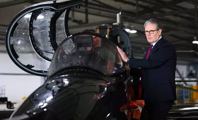 Britain's Prime Minister Keir Starmer is shown a Hawk T2, the RAF's premier fast jet trainer during a visit to RAF Valley, Anglesey, north Wales, Friday June 27, 2025. (Paul Currie/Pool via AP)