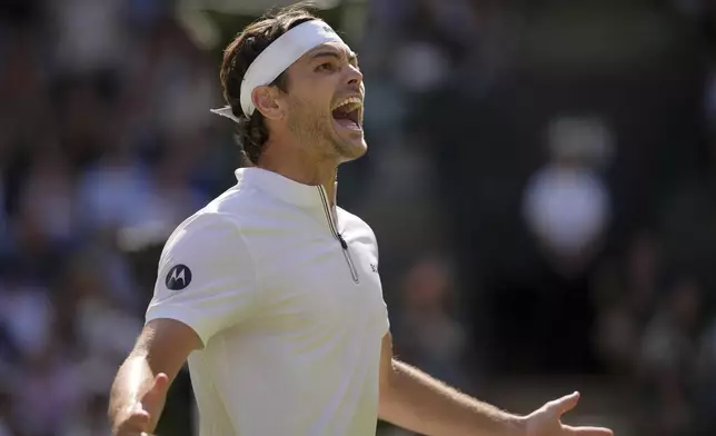 Taylor Fritz of the U.S. celebrates winning the men's singles quarter final match against Karen Khachanov of Russia at the Wimbledon Tennis Championships in London, Tuesday, July 8, 2025.(AP Photo/Kin Cheung)