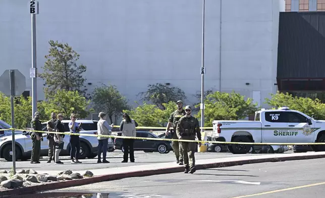 Police respond to a shooting outside the Grand Sierra Resort in Reno, Nev., Monday, July 28, 2025. (AP Photo/Andy Barron)
