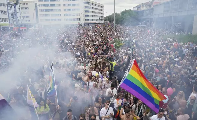 People dance as they take part in the LGBTQ annual pride march in Berlin, Germany, Saturday, July 26, 2025. (AP Photo/Ebrahim Noroozi)