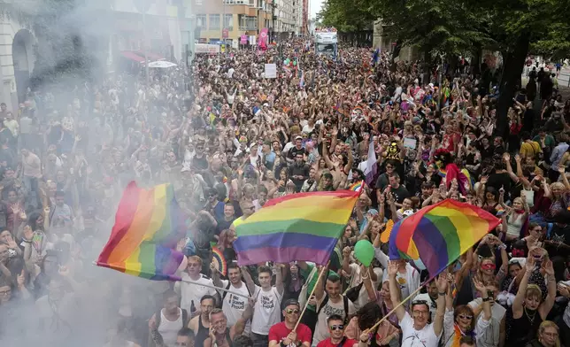 People dance as they take part in the LGBTQ annual pride march in Berlin, Germany, Saturday, July 26, 2025. (AP Photo/Ebrahim Noroozi)
