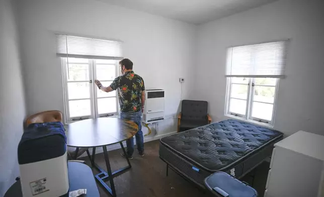 James Carey, housing director for the Friendship Shelter, gives a tour of the one of the apartments that the organization provides for homeless people, Monday, July 7, 2025, in San Clemente, Calif. (AP Photo/Denis Poroy)