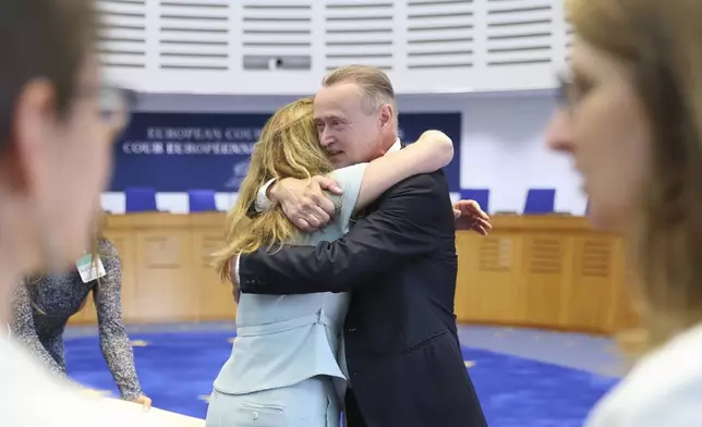 René Lefeber, right, deputy Legal Adviser of the Minister of Foreign Affairs of the Kingdom of the Netherlands, hugs agent to the European Court of Human Rights for Netherlands Babette Koopman after the European Court of Human Rights issued its judgment on Russian violations in Ukraine since 2014, including the downing of Malaysia Airlines flight MH17, Wednesday, July 9, 2025 in Strasbourg, eastern France. (AP Photo/Antonin Utz)