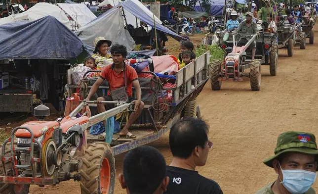 Cambodians sit on a cart of tractor as they take refuge in Batthkoa primary school in Oddar Meanchey province, Cambodia, Saturday, July 26, 2025, as border fighting between Thailand and Cambodia entered its third day. (AP Photo/Heng Sinith)
