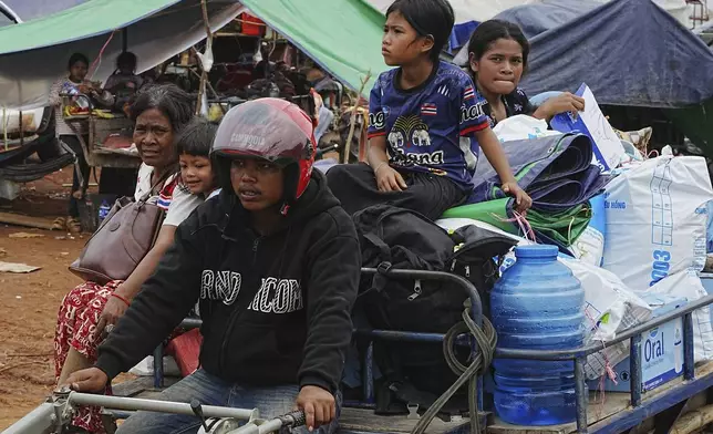 Cambodians sit on a tractor cart as they take refuge in Batthkoa primary school in Oddar Meanchey province, Cambodia, Saturday, July 26, 2025, as border fighting between Thailand and Cambodia entered its third day. (AP Photo/Heng Sinith)