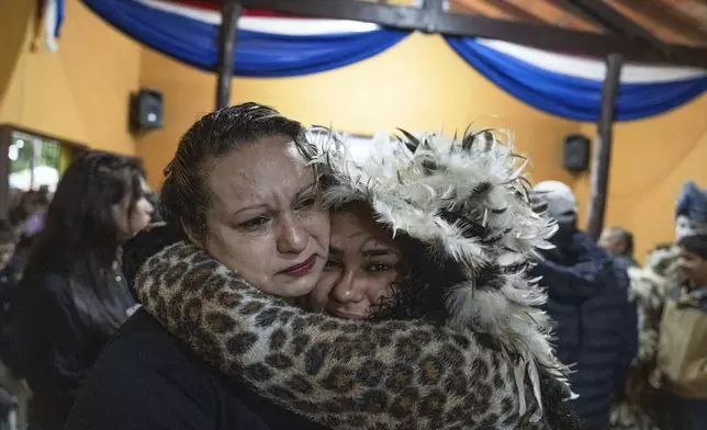 Faithful attend a Mass celebrating Saint Francisco Solano, in Emboscada, Paraguay, Thursday, July 24, 2025. Hundreds of Catholic parishioners in Paraguay don bird-like costumes and parade down the streets to honor the 16th century saint said to possess miraculous powers. (AP Photo/Jorge Saenz)