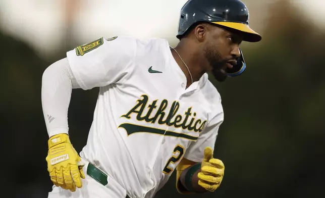 Athletics' Miguel Andujar rounds the bases after hitting a one run home run during the fourth inning of a baseball game against the Seattle Mariners Wednesday, July 30, 2025, in West Sacramento, Calif. (AP Photo/Sergio Estrada)