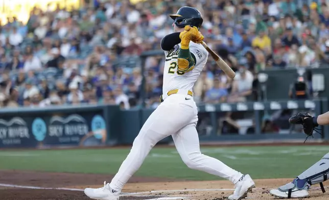 Athletics' Brent Rooker hits a one run home run during the first inning of a baseball game against the Seattle Mariners Wednesday, July 30, 2025, in West Sacramento, Calif. (AP Photo/Sergio Estrada)
