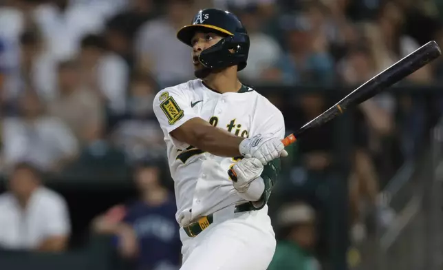 Athletics' Darell Hernaiz hits a one run home run during the fifth inning of a baseball game against the Seattle Mariners Wednesday, July 30, 2025, in West Sacramento, Calif. (AP Photo/Sergio Estrada)